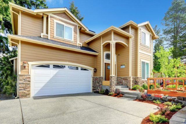 27261985 - luxury big house with garage and high column entrance porch.